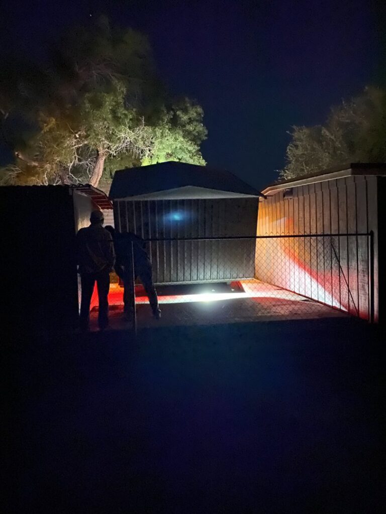 CC Wrecker Service team members working at night to place a portable metal storage building in Corpus Christi, TX.