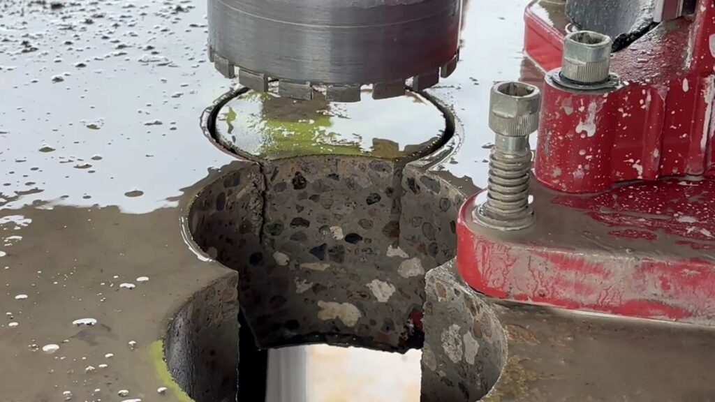 Close-up of precision concrete cutting with a core drill, a service provided by Valute Demolition in Jacksonville, FL.