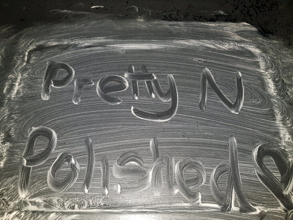 The business name 'Pretty N Polished' written in cleaning foam, showcasing attention to detail by Pretty & Polished Cleaning Services in Sandy, OR.