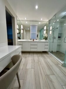 A pristine modern bathroom with a long vanity and a walk-in glass shower, cleaned by Glisten Co Cleaning Service in Worcester, MA.