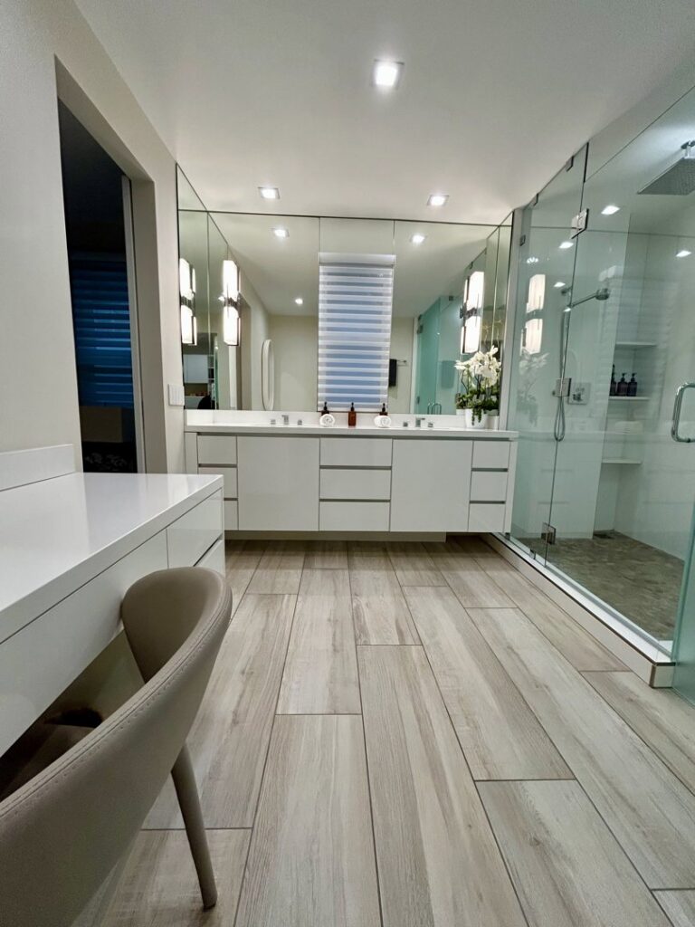 A pristine modern bathroom with a long vanity and a walk-in glass shower, cleaned by Glisten Co Cleaning Service in Worcester, MA.