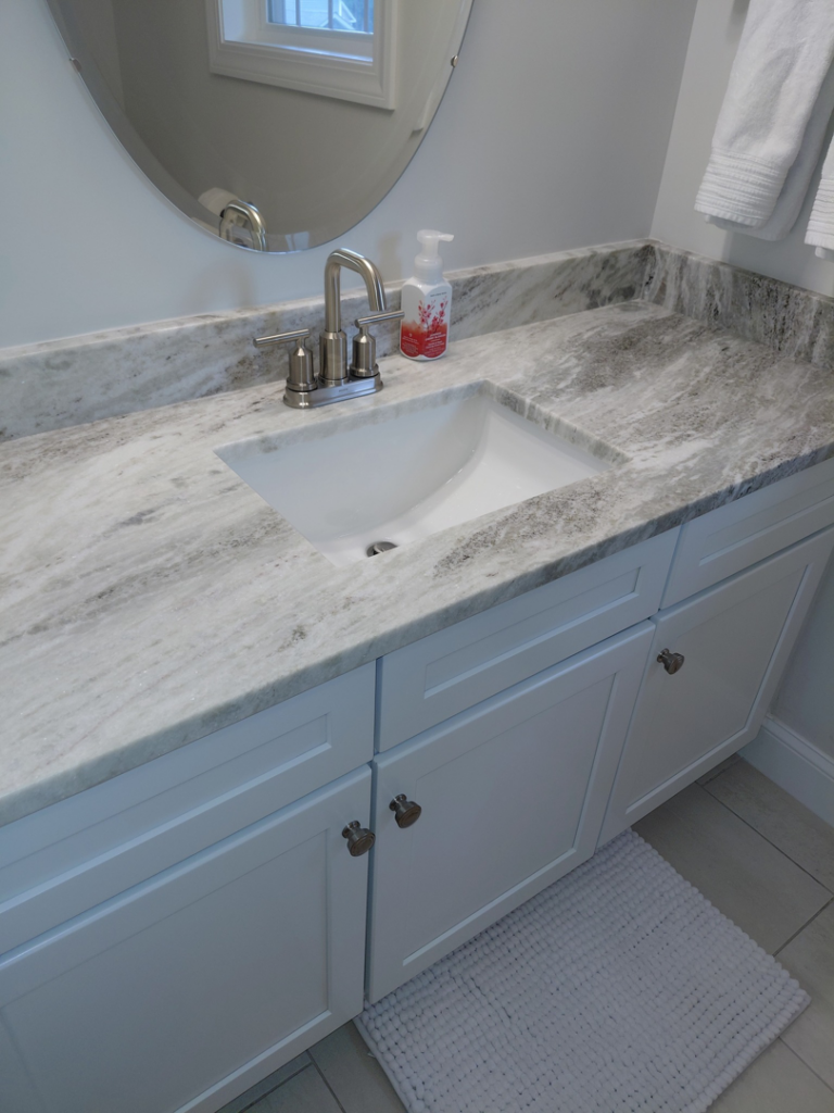 A pristine bathroom vanity with a clean sink and mirror, cleaned by White Lotus Cleaning Services LLC in Nashua, NH.