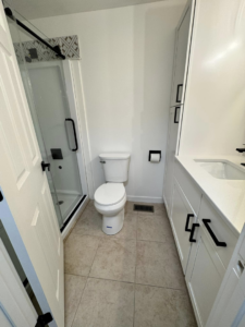 A pristine bathroom with a clean shower, toilet, and vanity, cleaned by Dust Detail Cleaning Services in Post Falls, ID.