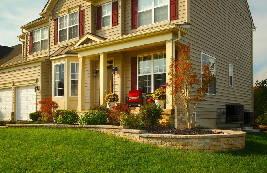 A pristine front lawn with attractive landscaping, showcasing the work of Bailey's Lawn and Landscape in Smyrna, DE.