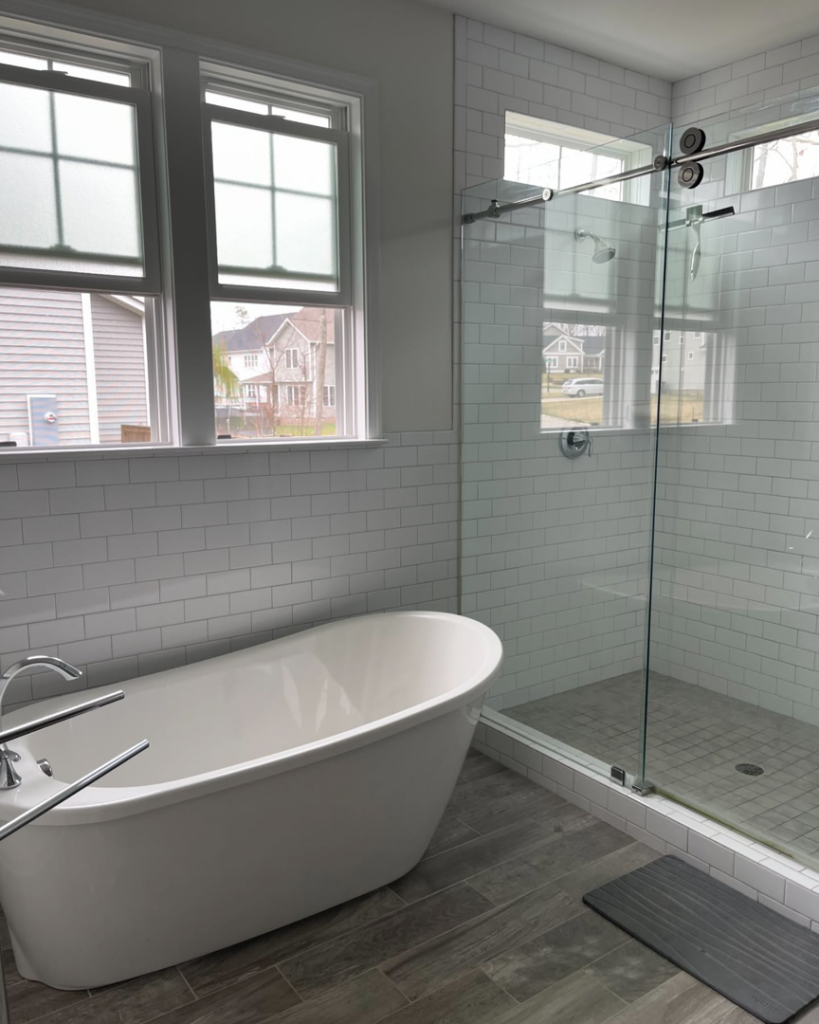A pristine modern bathroom featuring a freestanding tub and glass shower, cleaned by Per Your Request Richmond in Glen Allen, VA.