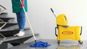 A professional cleaner mopping a set of stairs, showcasing attention to detail by 360clean in North Charleston, SC