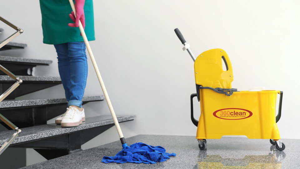 A professional cleaner mopping a set of stairs, showcasing attention to detail by 360clean in North Charleston, SC