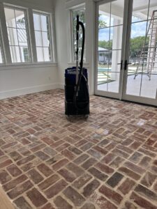 Professional floor cleaning equipment on a brick floor, indicating deep cleaning services by Simply Clean Jax in Jacksonville, FL.