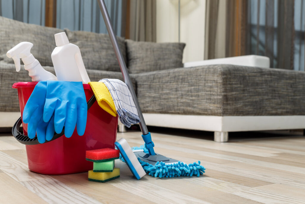 Professional house cleaning supplies including a bucket, mop, and spray bottles, ready for use by Cleaners of Arizona in Chandler, AZ.