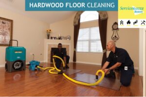 A ServiceMaster of Lawton house cleaner professionally wiping down a large table surface in Lawton, OK.