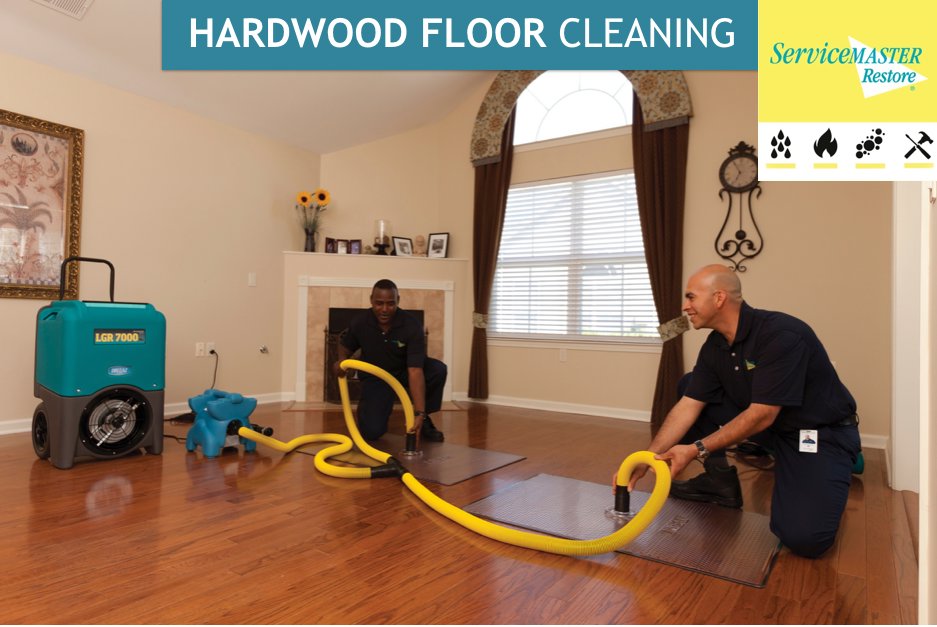 A ServiceMaster of Lawton house cleaner professionally wiping down a large table surface in Lawton, OK.