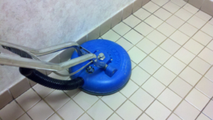 A professional tile floor cleaning machine in action, providing deep cleaning services by Score Maintenance Services, LLC in Paterson, NJ.