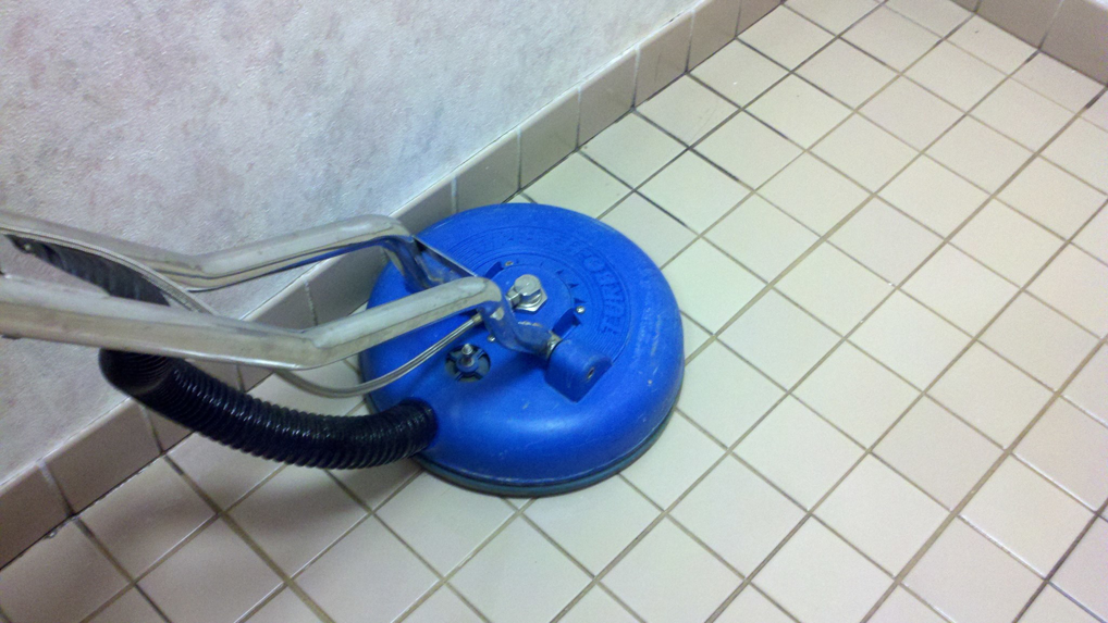 A professional tile floor cleaning machine in action, providing deep cleaning services by Score Maintenance Services, LLC in Paterson, NJ.