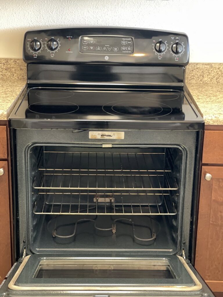 A professionally cleaned oven with sparkling racks and interior, highlighting deep cleaning services by 307 Maid in Cheyenne, WY.