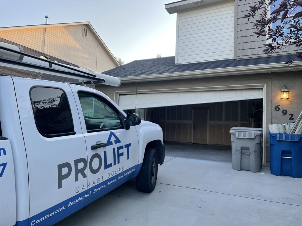 A ProLift Garage Doors of Canyon County service truck parked at a residential home with the garage door partially open in Nampa, ID.