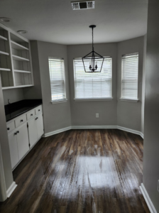 A recently mopped dining nook with built-in cabinets and bay windows, showcasing clean floors by S&M Cleaning Services 5 LLC in Cocoa, FL.