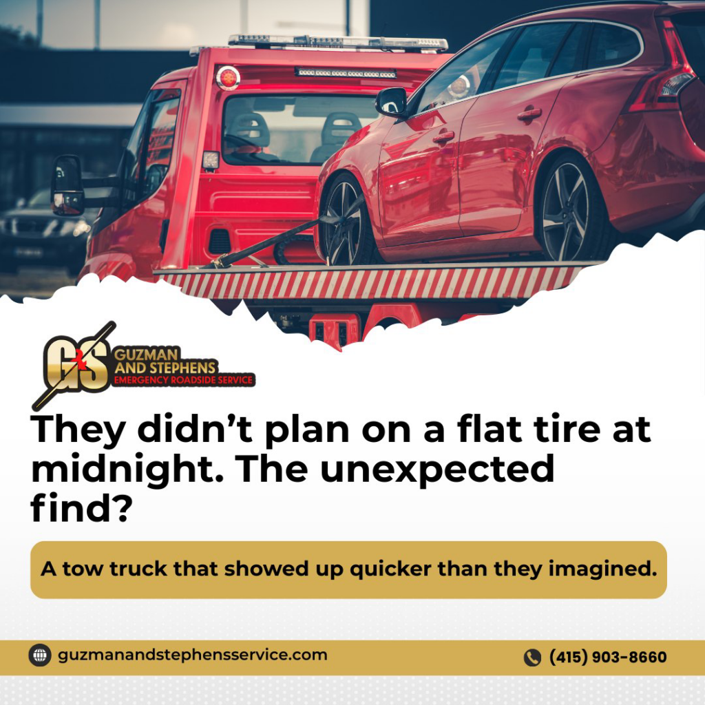 A red car being transported on a flatbed tow truck by Guzman Towing Services in Oakland, CA.