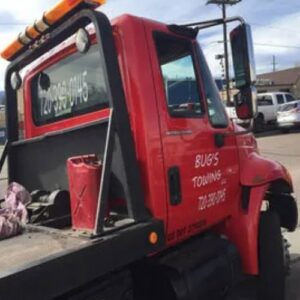 A red flatbed tow truck ready for service from Towing Colorado in Colorado Springs, CO.