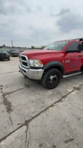 A red flatbed tow truck transporting a red pickup truck for RDZ Towing Service 24/7 in Dallas, TX.