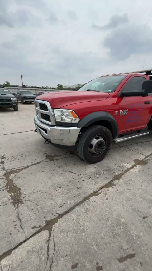 A red flatbed tow truck transporting a red pickup truck for RDZ Towing Service 24/7 in Dallas, TX.