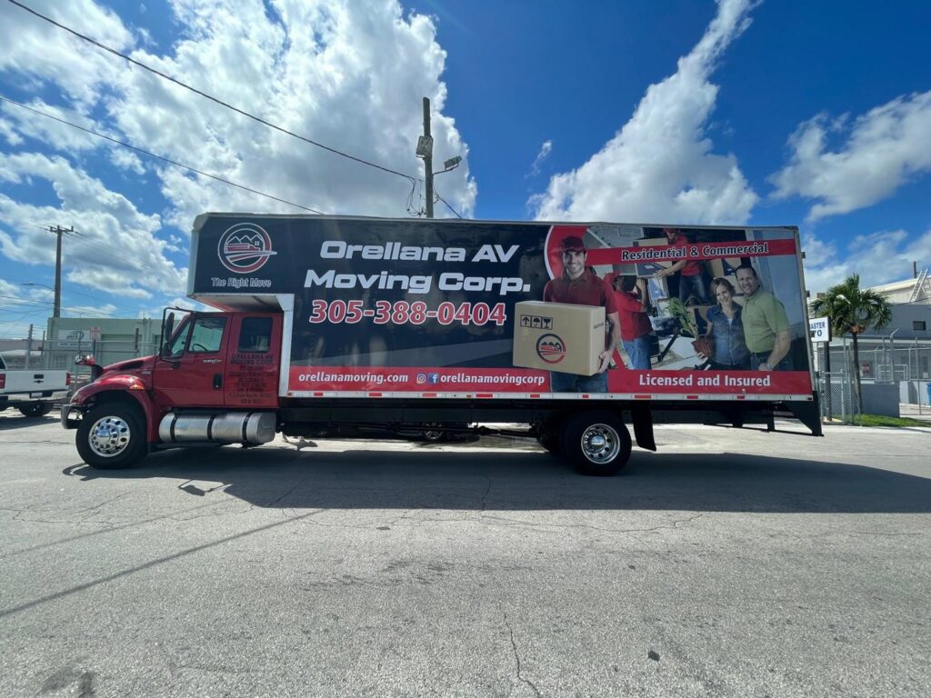 A branded red moving truck from Orellana AV Moving Corp. parked on a street in Miami, FL, ready for service.
