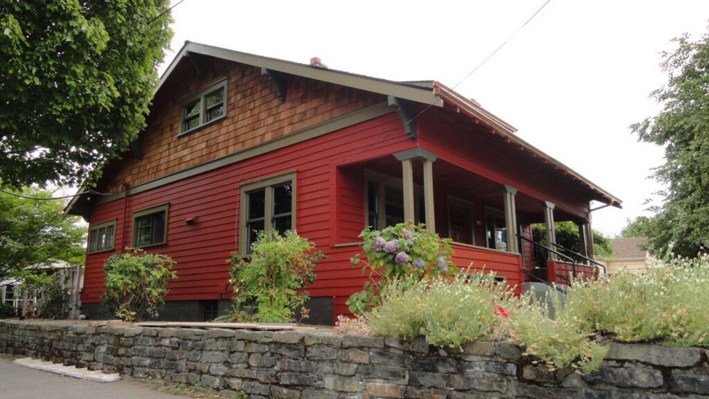 A house with red horizontal siding and wood shake gable siding by Lifetime Remodeling Systems in Portland, OR.