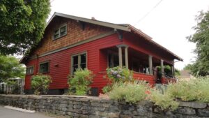 A house with red horizontal siding and wood shake gable siding by Lifetime Remodeling Systems in Portland, OR.