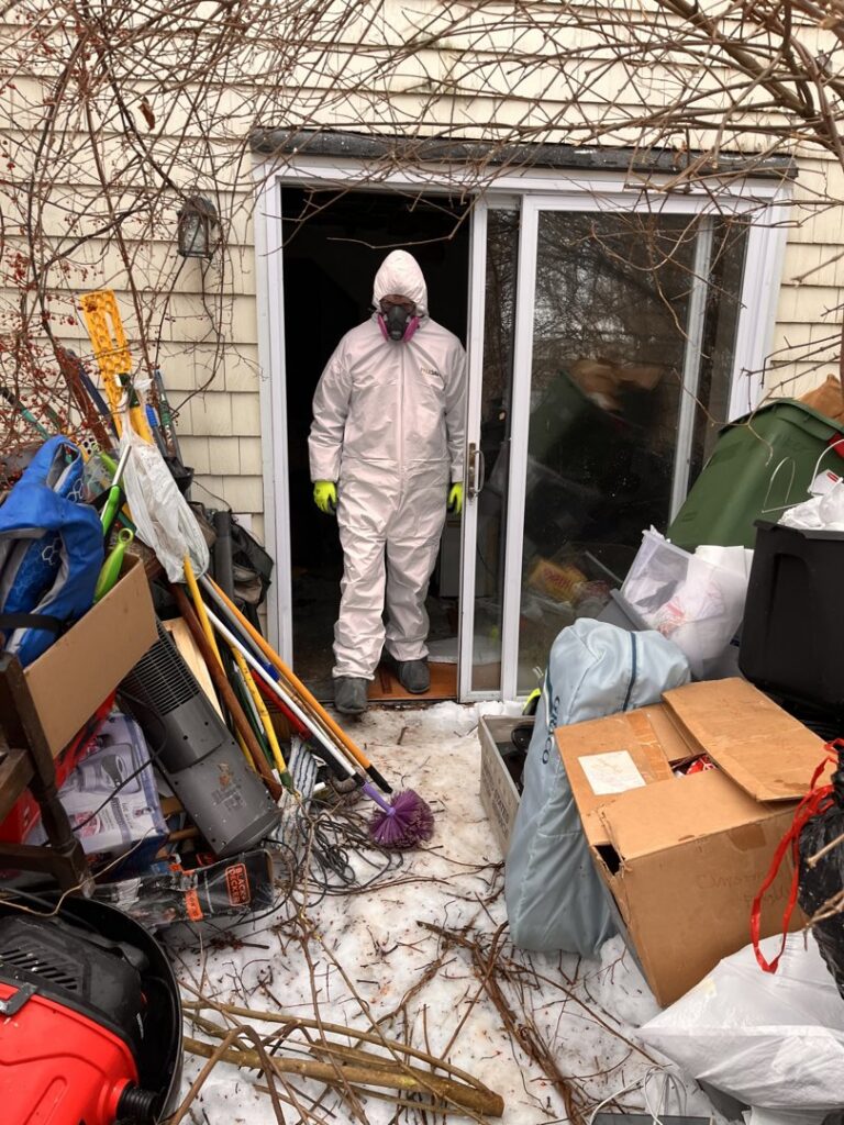 A Paul Davis Restoration of Greater Portland, ME remediation worker in a hazmat suit at a job site in Falmouth, ME.