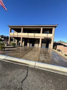 A residential driveway with blue tape after professional cleaning by Farki Pressure Washer LLC in Mesquite, NV