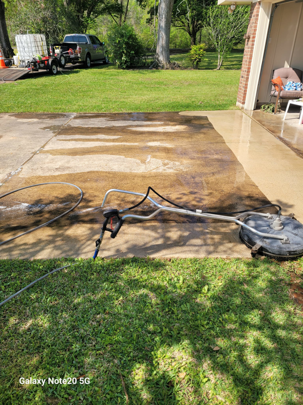 A residential driveway being pressure washed by Top2Bottom Pressure Washing & Exterior Cleaning in Alexandria, LA.