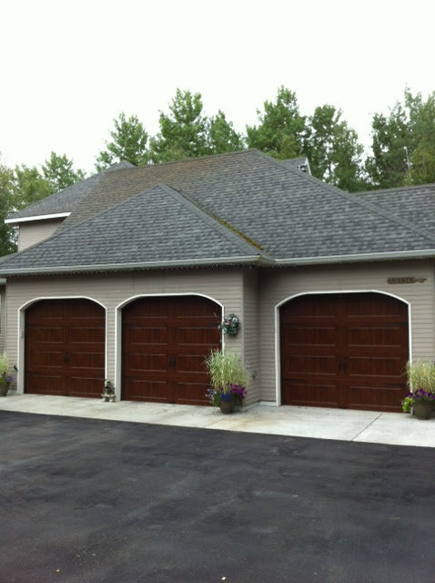 Three newly installed residential garage doors on a house by Klondike Door Service in Fairbanks, AK