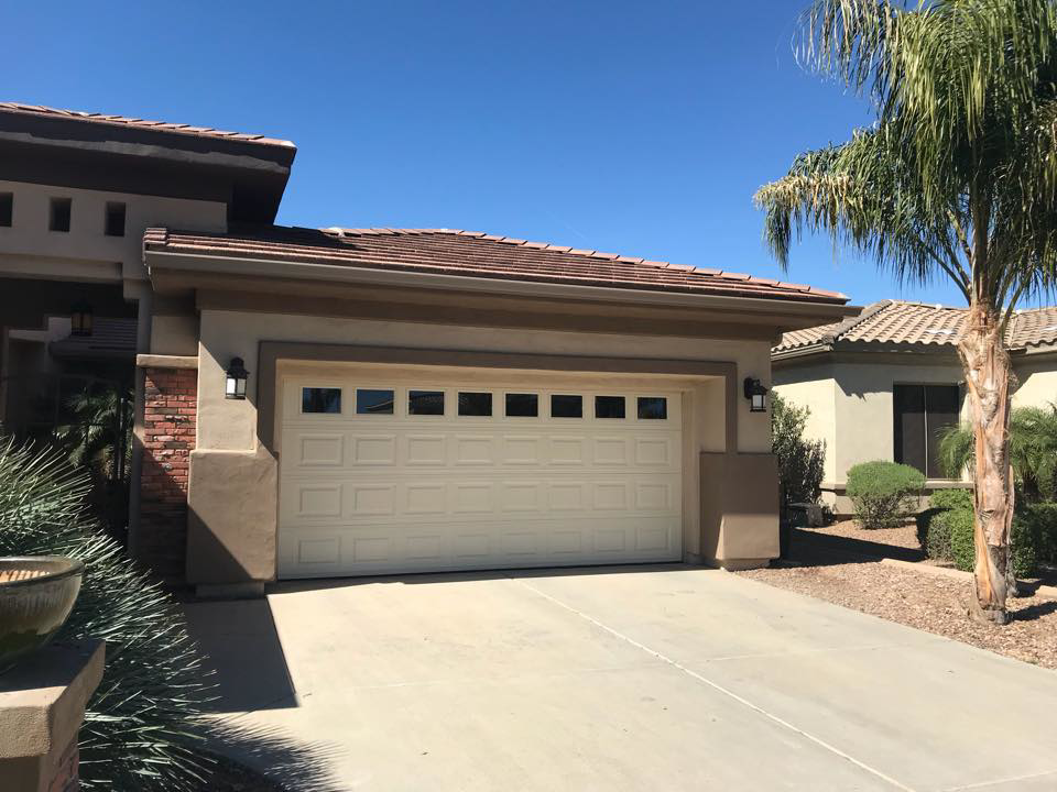 A newly installed residential garage door with windows by MBP Garage Doors in Firth, ID