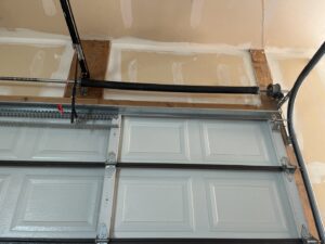 Close-up view of a residential garage door's torsion spring system, indicating installation or repair work by Right Choice Doors in Layton, UT.