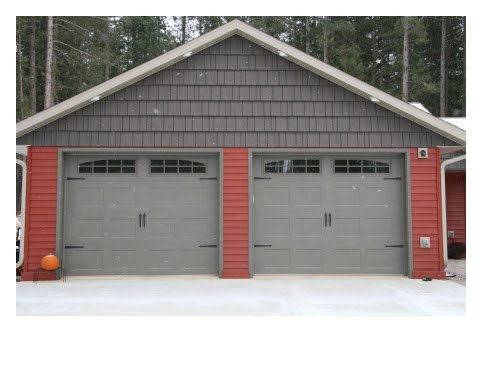 Two residential grey garage doors with decorative windows and hardware by Vertical Door Solutions in Sheridan, WY
