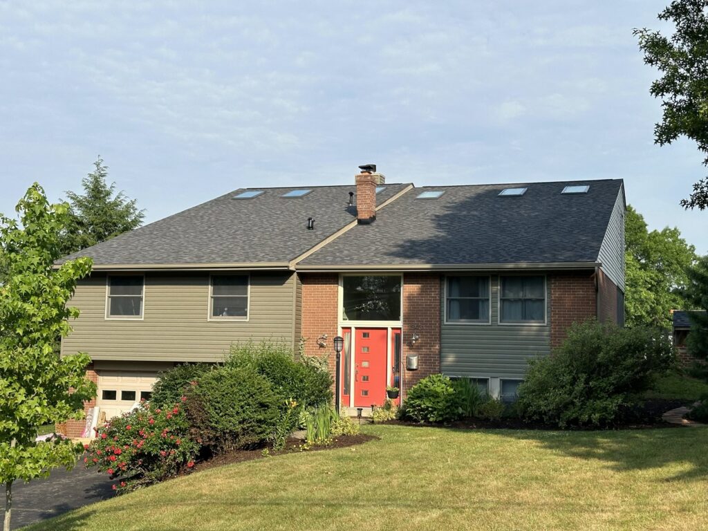 A residential home featuring new green-tan siding and a recently installed roof by My Guys Remodeling Experts in Bethel Park, PA.
