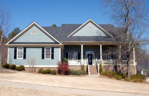 Residential home with light blue siding and front porch, a project by Corpus Christi Siding Pros, Corpus Christi, TX.