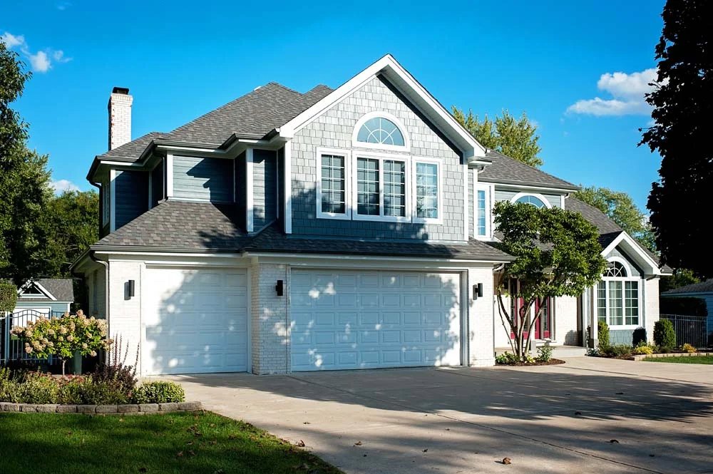Residential house with blue siding and white brick completed by SmardBuild Siding and Exteriors in Naperville, IL