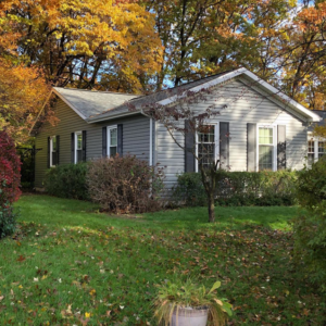 A residential house featuring new gray vinyl siding, completed by Exterior Building Products in Indianapolis, IN.