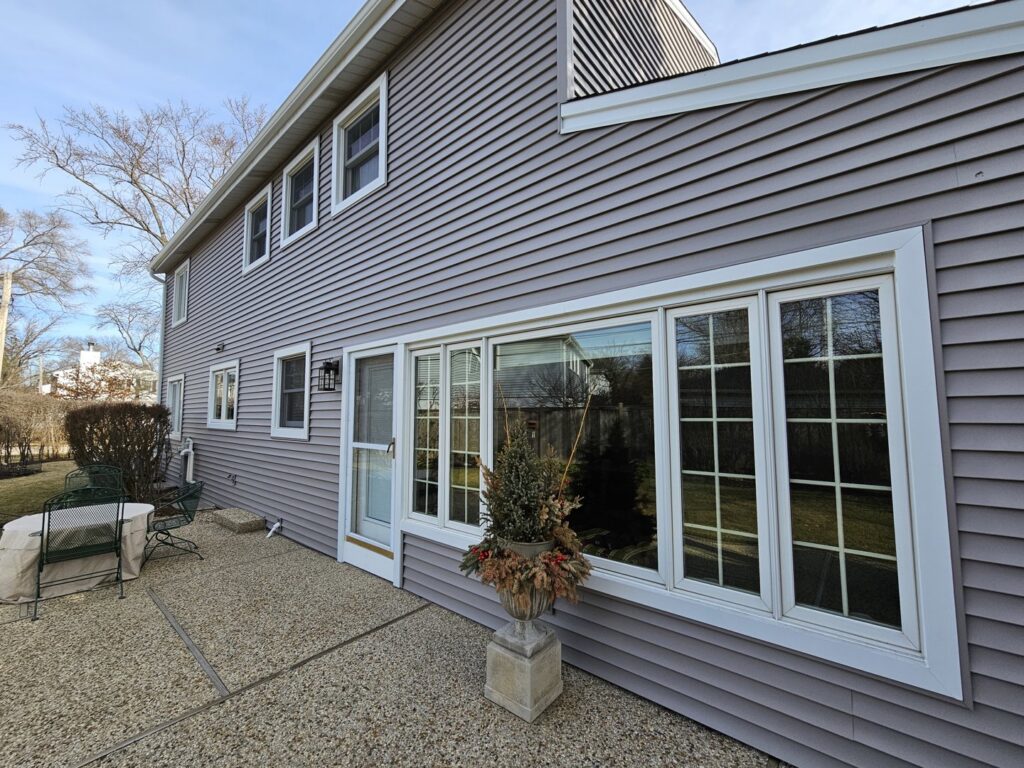 A residential house showcasing newly installed light gray siding by A&D Exteriors, a contractor in Naperville, IL.