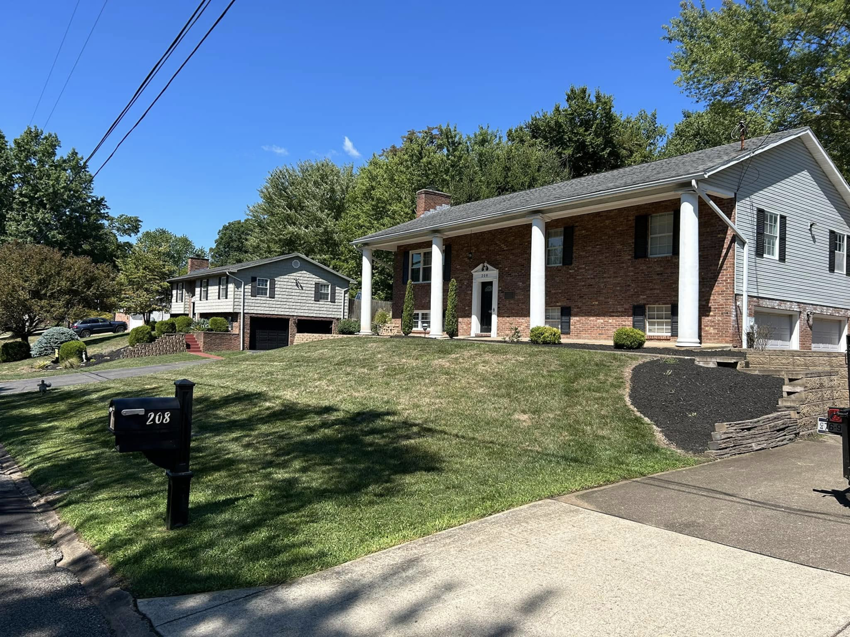 Beautifully maintained residential lawns with crisp mowing stripes and landscaping by Taylor's Trimmings in Parkersburg, WV.