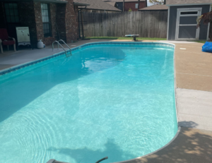A residential swimming pool with clean, clear blue water, reflecting the quality service of AquaDocs in Dublin, OH.