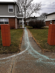 A residential walkway treated with ice melt by 10.7 Property Solutions LLC in South Bend, IN