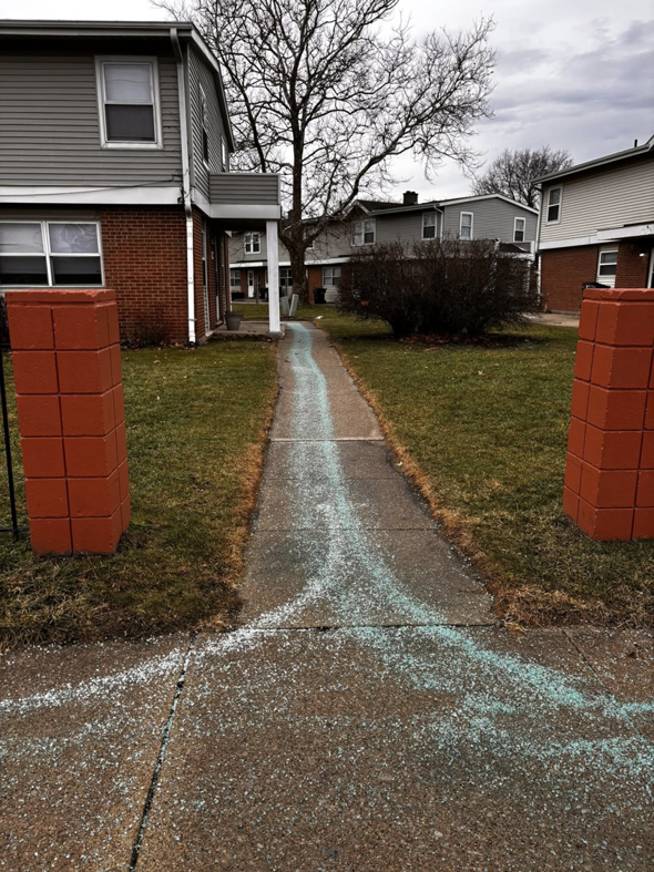 A residential walkway treated with ice melt by 10.7 Property Solutions LLC in South Bend, IN