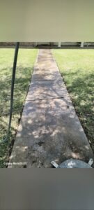 A residential walkway being pressure washed by Top2Bottom Pressure Washing & Exterior Cleaning in Alexandria, LA.