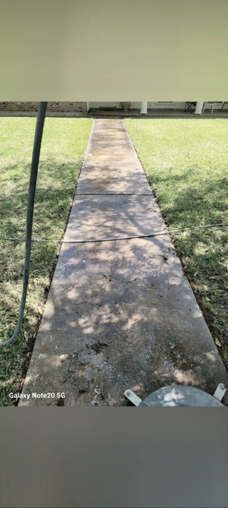 A residential walkway being pressure washed by Top2Bottom Pressure Washing & Exterior Cleaning in Alexandria, LA.