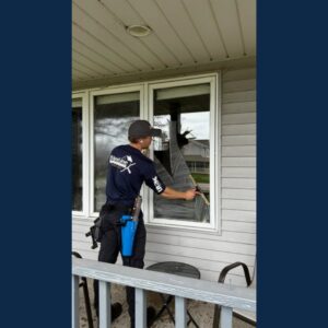 A professional cleaner using a squeegee to clean a residential window, a service offered by Blue Line Cleaning Services in Rock Hill, SC.