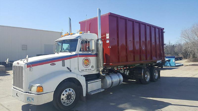 A roll-off dumpster truck used for debris removal, part of services by Enfield Demolition & Excavation LLC in Enid, OK.