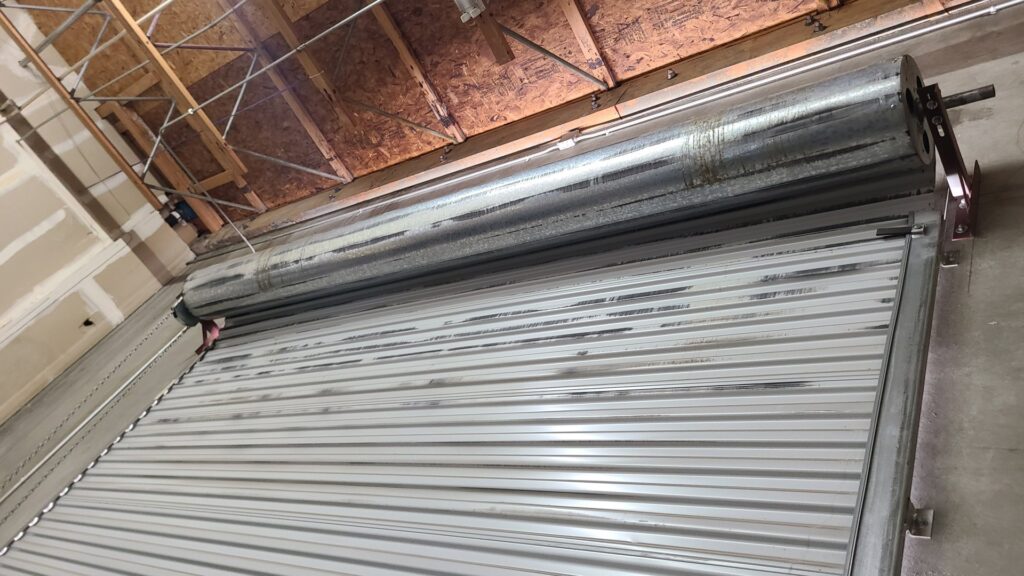 Close-up of a rolling garage door mechanism during installation or service by USA Doors in Doral, FL.