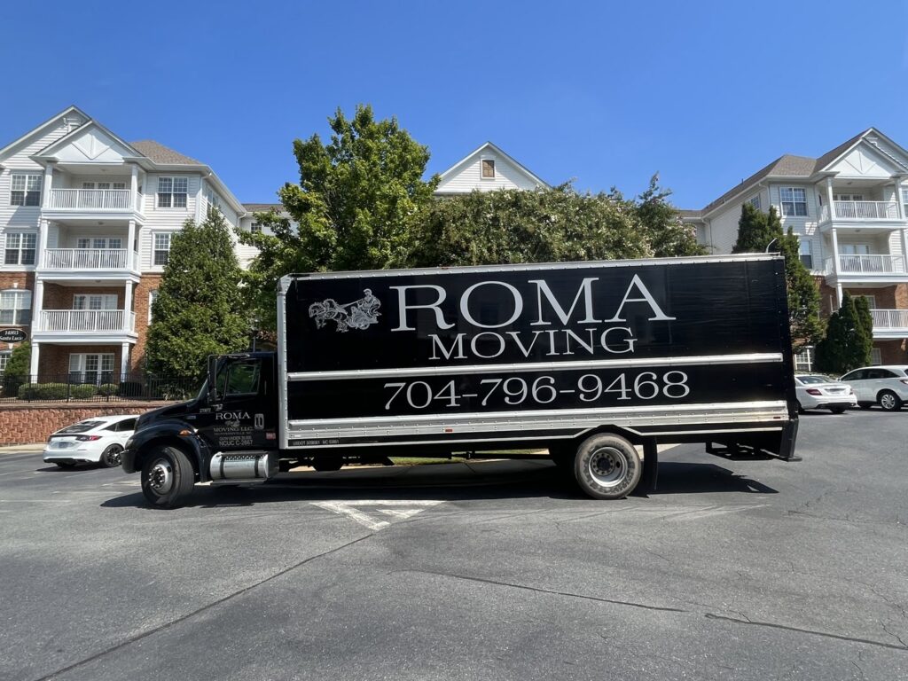 A Roma Moving truck parked in front of an apartment complex, ready for a residential move in Charlotte, NC.