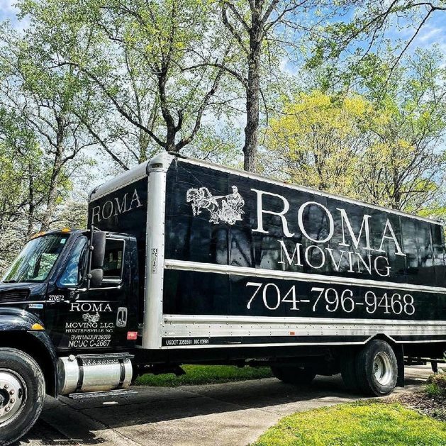 A black Roma Moving truck with the company logo and phone number parked under trees in Charlotte, NC.